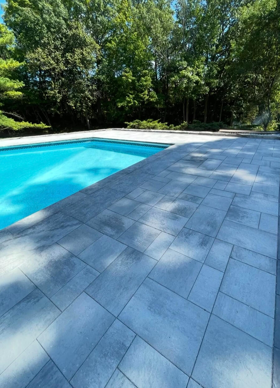 Modern interlock patio and pool deck with clean lines.