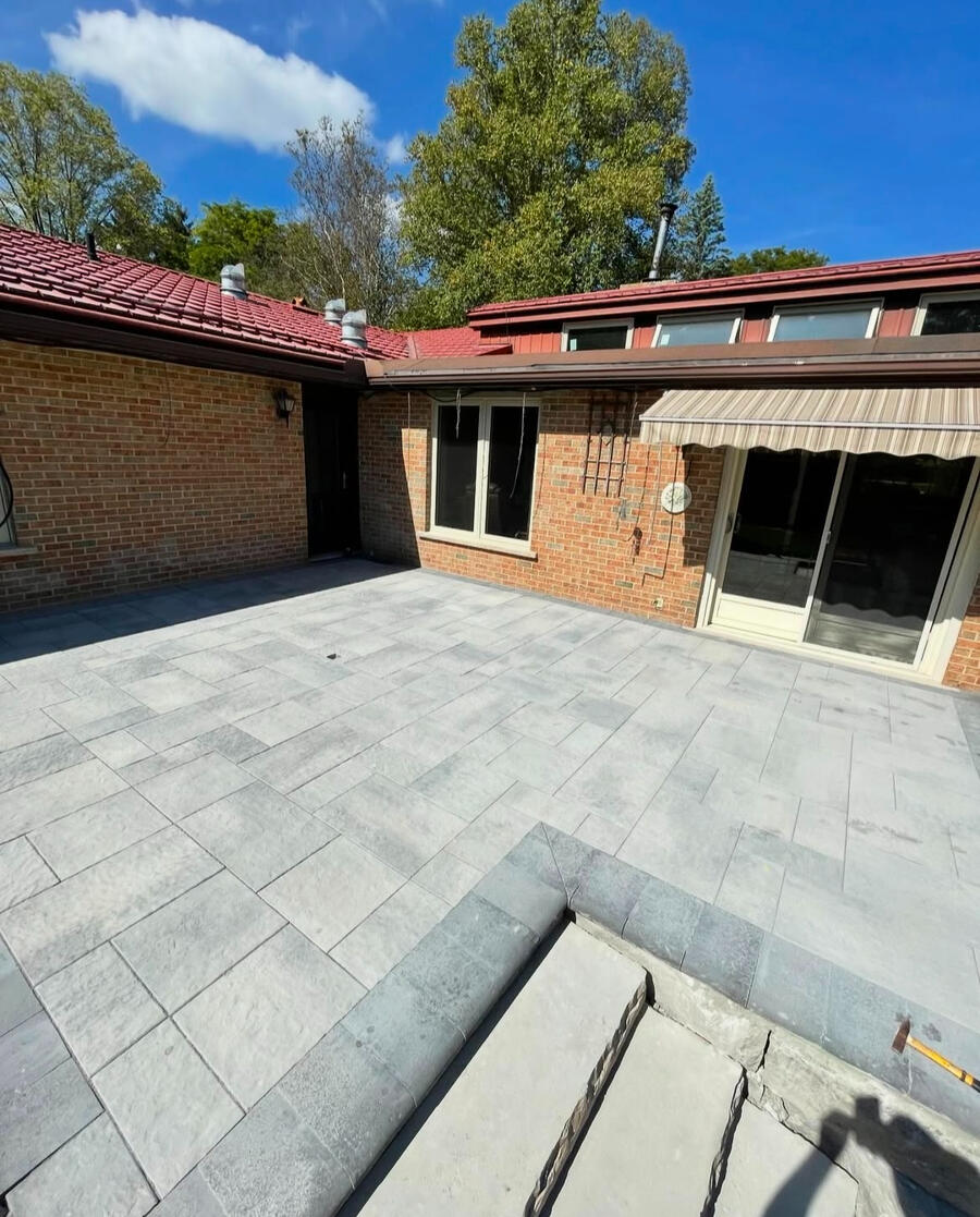 Backyard interlock patio off a red brick home in Whitby.