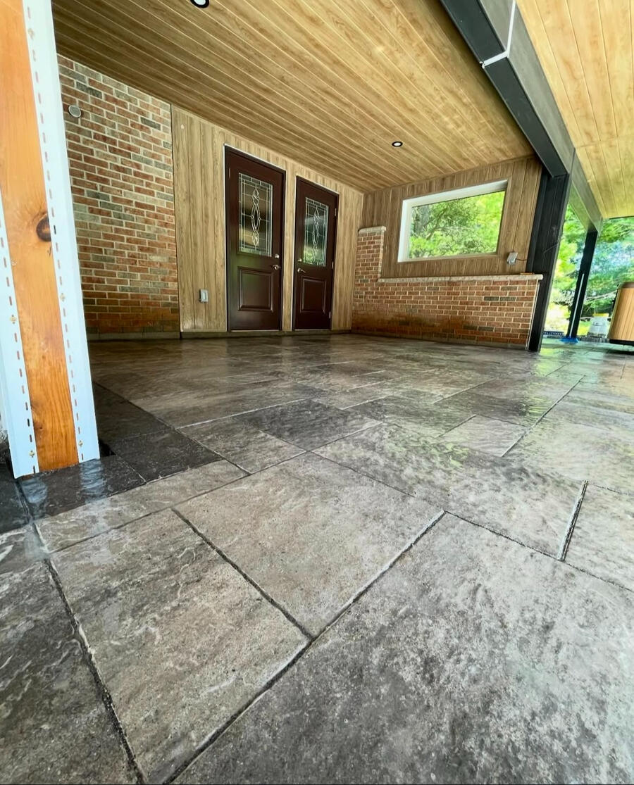 Covered porch with dark stone-look tile floor in the GTA.