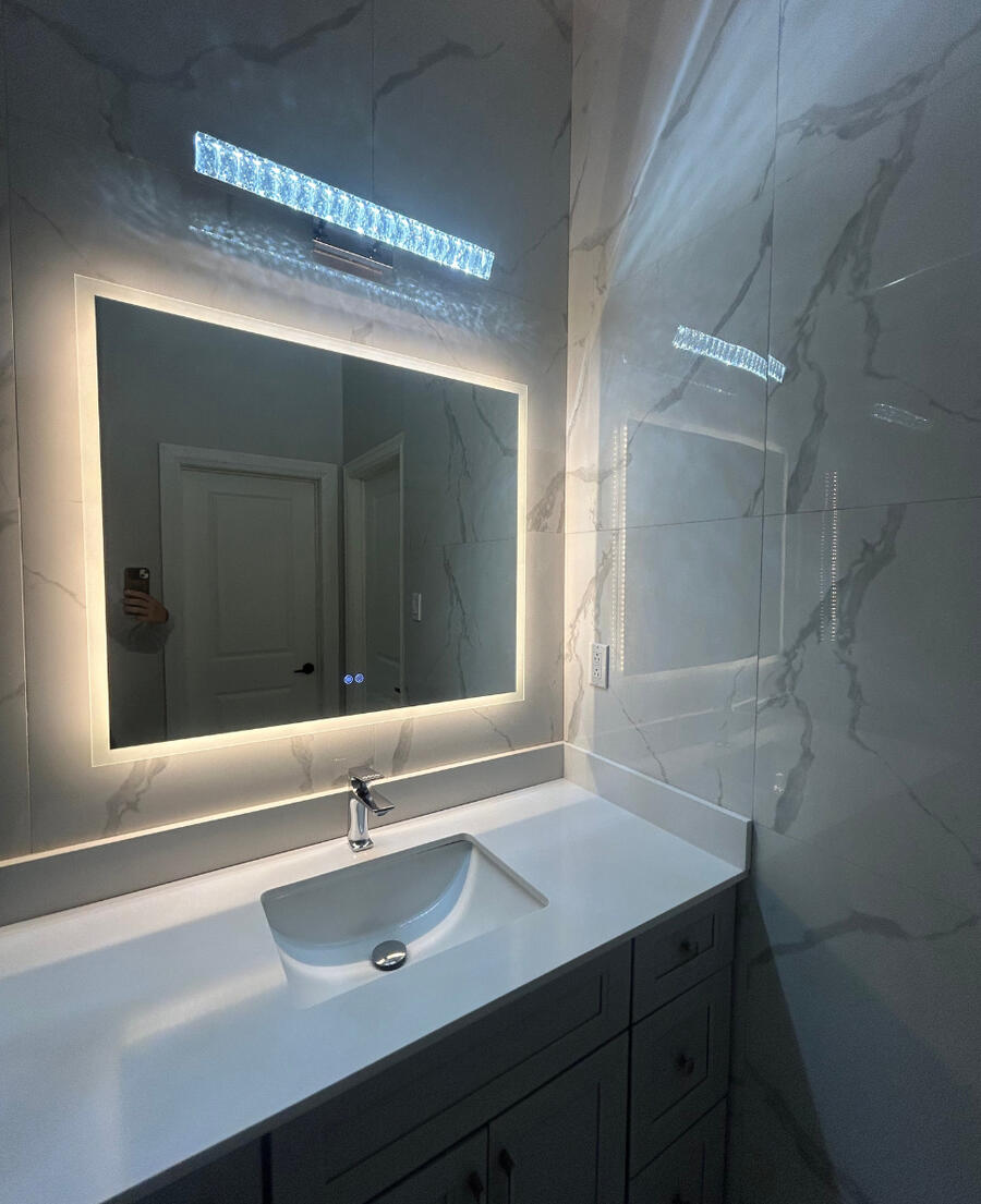 Backlit bathroom mirror and marble feature wall completed in Whitby.