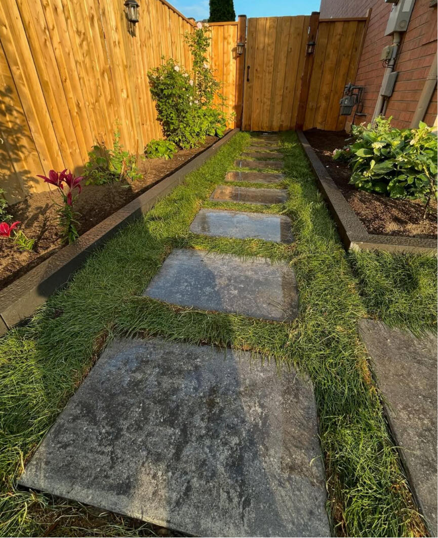 Stepping stone garden path set in new sod and beds.